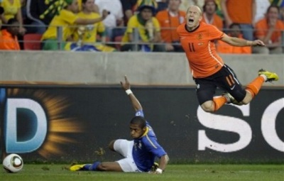Netherlands' Arjen Robben, right, reacts after being tackled by Brazil's Michel Bastos, left, during the World Cup quarterfinal soccer match between the Netherlands and Brazil at Nelson Mandela Bay Stadium in Port Elizabeth, South Africa, Friday, July 2, 2010. (AP Photo/Martin Meissner)